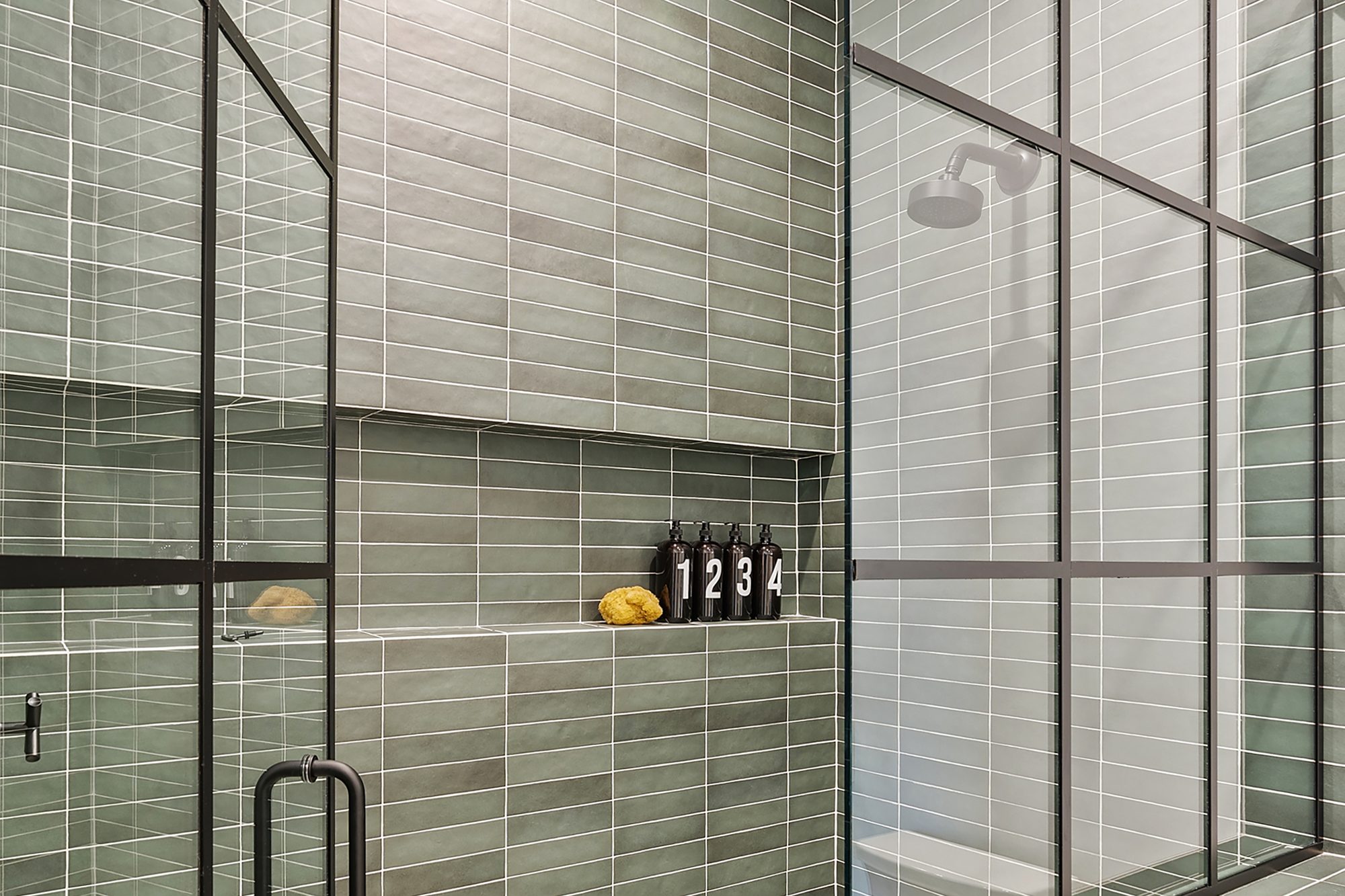 Bedrosians Makoto ceramic wall tile shower - Kirkpatrick Floors Walk-in glass shower lined with green Bedrosians Makoto ceramic wall tile