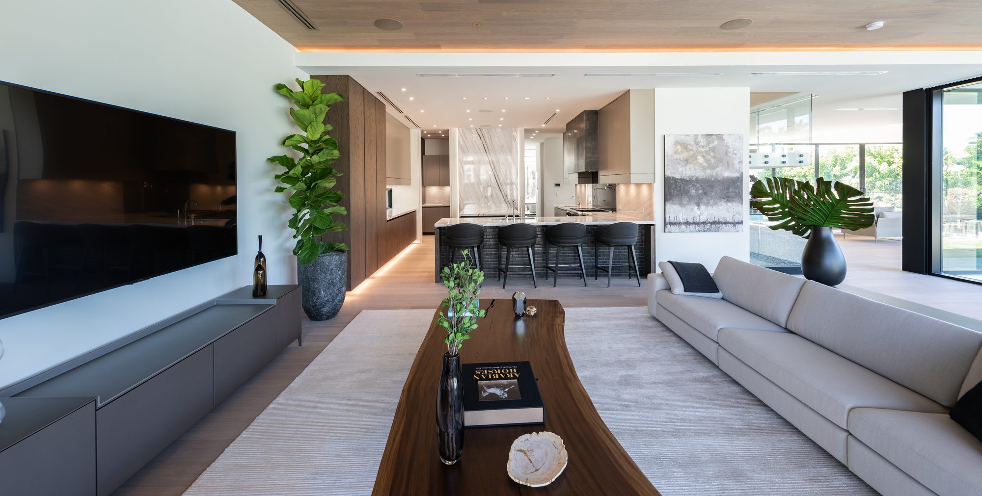 Havwoods Venture Plank engineered hardwood living room - Kirkpatrick Floors Open living room and kitchen in a Miami Beach villa with wide plank Havwoods Venture Plank engineered hardwood